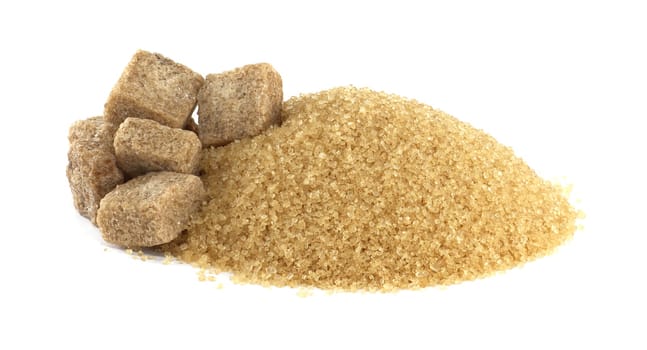 A close-up studio shot featuring a pile of brown sugar alongside a cluster of brown sugar cubes on a clean, white background.