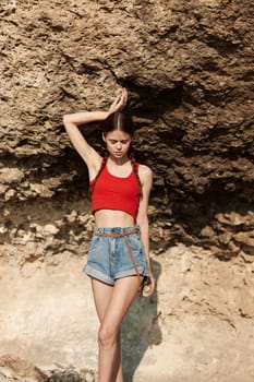 Woman relaxing on beach in stylish outfit with hands on head enjoying vacation beauty and fashion concept
