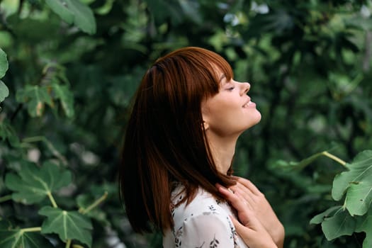 joyful woman celebrating in lush greenery with arms raised