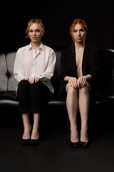 Full body of confident serious young female manager with ginger hair in elegant transparent white shirt and black suit on bare body