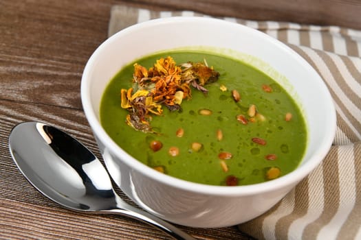 RECIPE FOR LEEK AND POTATO SOUP WITH GOLDEN PINE NUTS AND DRIED FLOWERS, High quality photo