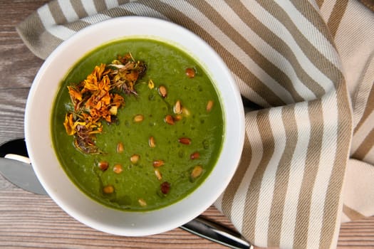 RECIPE FOR LEEK AND POTATO SOUP WITH GOLDEN PINE NUTS AND DRIED FLOWERS, High quality photo