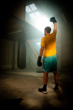 A dedicated and focused boxer trains diligently in a serene, quiet gym, showcasing incredible strength and perseverance