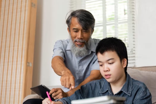 A lively interaction where a grandfather points out important details while his grandson studies, showcasing the joy of learning together.