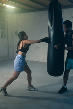 An exciting training session features a woman boxing a bag, enhancing her fitness and strength dramatically