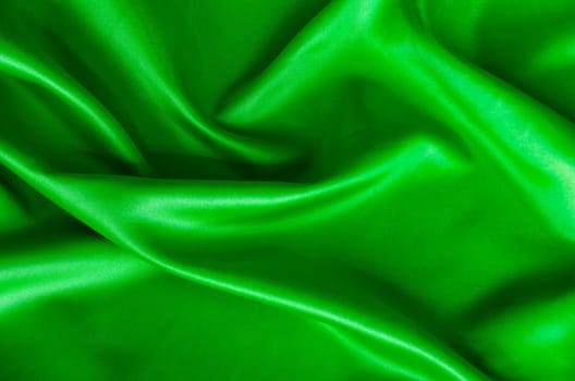 Polished dark green silk cloth with silky sheen and beautiful natural draping. Suitable for design and wallpaper background.