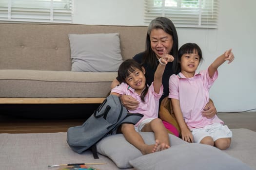 Two young girls enjoy a joyful moment with their grandmother, highlighting the importance of family bonds and shared experiences.