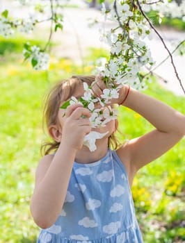 Child in a garden of flowering trees. Selective focus. kid.