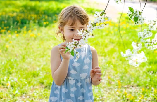 Child in a garden of flowering trees. Selective focus. kid.