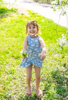 Child in a garden of flowering trees. Selective focus. kid.