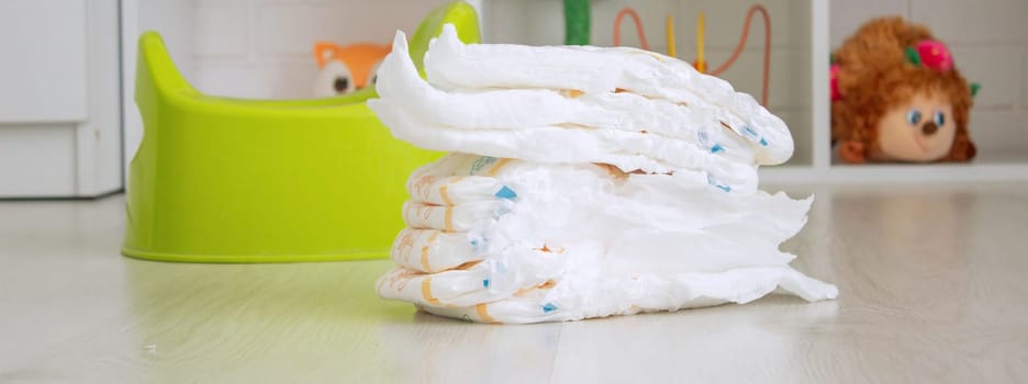 Green potty and toilet paper in the room