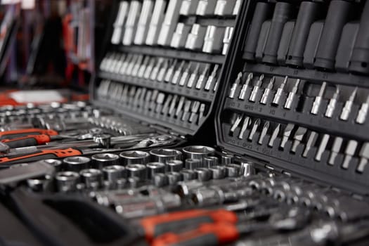 Tool box with kit of wrenches, screwdrivers, spanners and nuts for mechanic service. Hardware store assortment and great choice. Closeup selective focus of repairman instrument