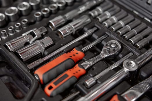 Closeup of tool box with kit of wrenches, screwdrivers, spanners and nuts for mechanic service. Hardware store assortment and great choice. Closeup selective focus of repairman instrument