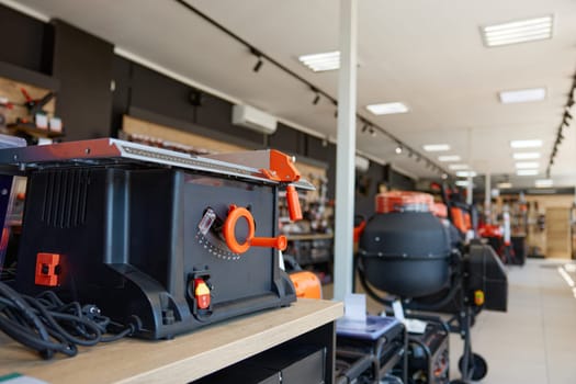 Modern table saw display at professional hardware store offering woodwork tools wide assortment. Carpentry shop with equipment for workplace organization