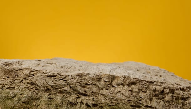 Stones on yellow background, stage for advertising and product demonstration, copy space