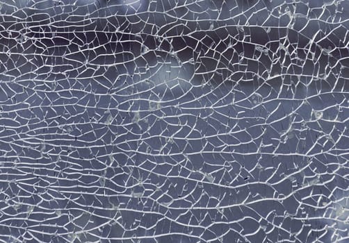 Newcastle, UK - Apr 11, 2025 - Detail of broken tempered glass pane too many small irregular shape pieces holding together. Texture of cracked broken glass cracked by impact, Cracks on the glass surface background, use it as your Wallpaper, Poster and Copy space, Selective focus.