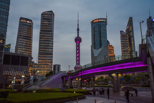 Shanghai, China - 1 April 2025: Oriental Pearl Tower at dusk with Pudong skyline. City lights reflecting on Huangpu River. Urban nightscape.