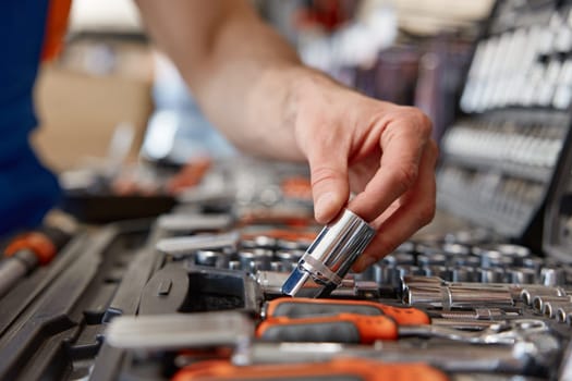 Foreman checking socket wrenches in tool box at hardware store. Universal metalworking tools sale and wide assortment
