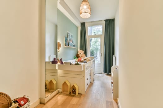 A spacious interior hallway with a playful design, featuring a mirror, decorative elements, and ample natural light. The stylish decor enhances the inviting atmosphere.