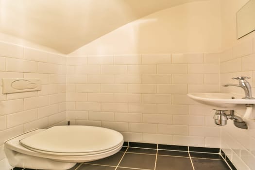 A sleek modern bathroom featuring pristine white tiles, a minimalist toilet, and an elegant wash basin. The clean lines and soft lighting create a serene atmosphere.