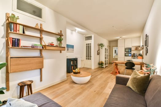 A cozy and modern living space featuring minimalist furniture, warm tones, and decorative plants, creating a tranquil atmosphere for relaxation.