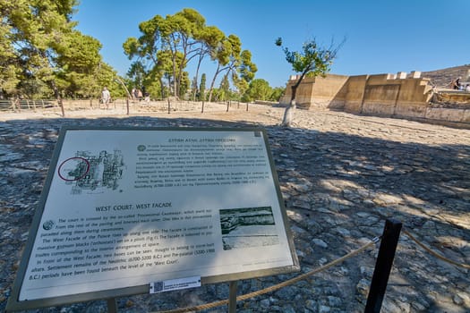 Crete.Greece - april 24, 2025: Informational sign at Knossos archaeological site, explaining the West Court and West Facade of the palace with historical facts, diagrams, and images.