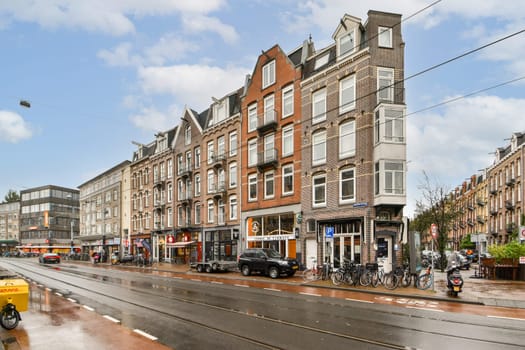 A vibrant streetscape showcasing Amsterdam's distinctive architecture and lively urban atmosphere. Shops and bicycles align with the classic buildings.