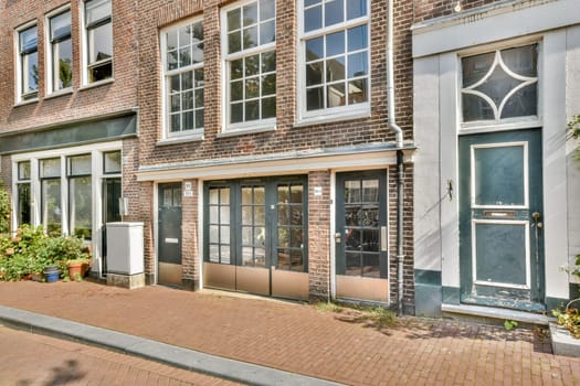An inviting street view of a historic Dutch building showcasing its brick facade and large windows, surrounded by lush greenery. A glimpse into architectural beauty.