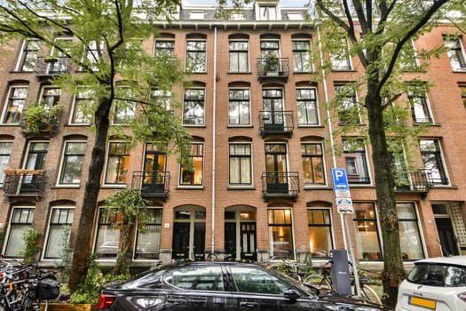 A picturesque street showcasing a classic brick building surrounded by greenery and bicycles, highlighting urban charm and lifestyle.