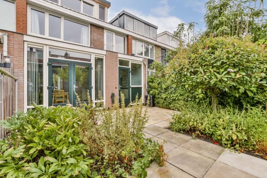 A contemporary home surrounded by vibrant gardens and pathways, showcasing the beauty of modern landscaping and outdoor living spaces.