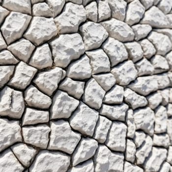 Abstract background of a wall made of white stones, closeup