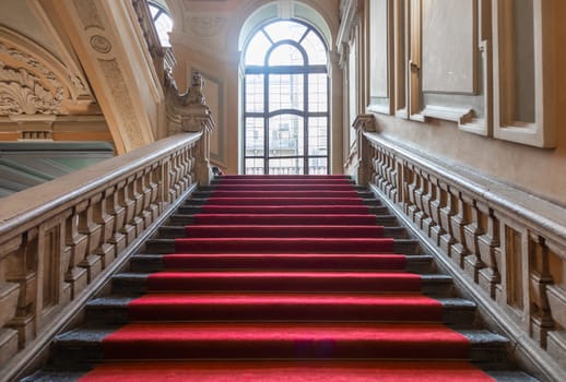 Turin, Italy - January 2023: Palazzo Barolo staircase. Luxury palace with old baroque interior and red carpet