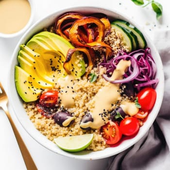 Healthy bowl with quinoa, avocado, tomatoes, cucumber, and red onion