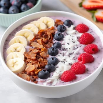 Yogurt with granola, banana, and berries in a bowl