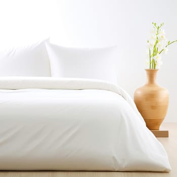 White pillows on the bed and vase with lilies of the valley