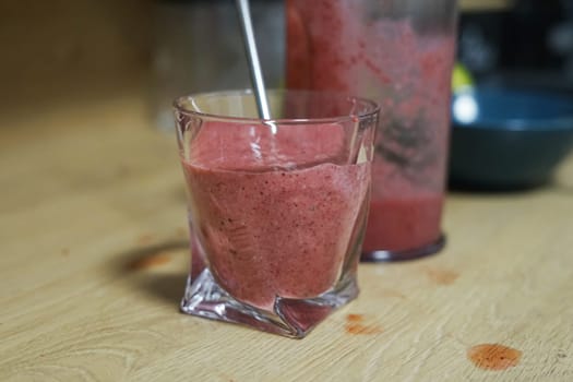 Strawberry smoothie or milkshake in a glass with eco reusable straw Summer cold fresh drink. Healthy diet food snack nutritious detox. High quality photo