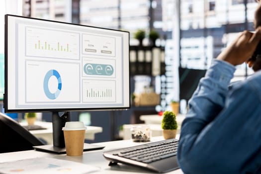 Businessman studying infographics and performance metrics for decision making, focused on project goals. Executive assistant managing business tasks and reviewing data, showcasing expertise.