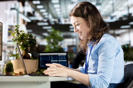 Office employee examining performance metrics numbers at the workplace, working on budget analysis and financial report as a business operation. Multinational company management.