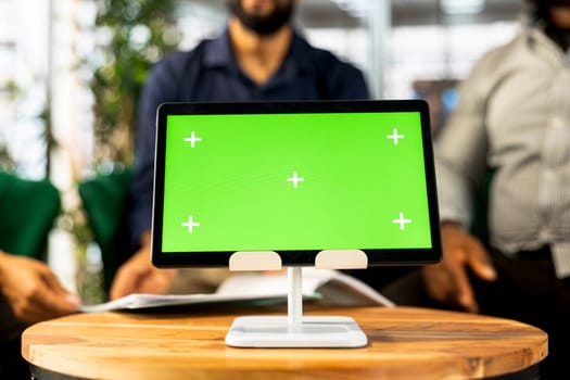 Board of directors in office maintaining strong relationships with business partners, looking at metrics on green screen tablet. Company director shows shareholders data on chroma key device, closeup