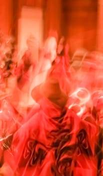 Background imagery of red motion and colour fusion swirling dance effect.