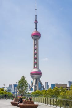 Shanghai, China - 1 April 2025: The iconic Oriental Pearl Tower dominates the skyline, its spheres glowing in daylight