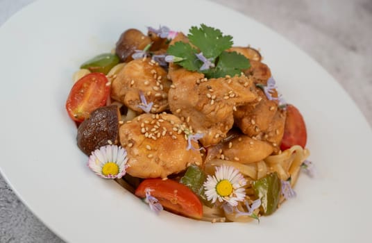 A flavorful blend of chicken, linguine, shiitake mushrooms, bell peppers, and fresh garden flowers offers a vibrant and appetizing meal. Ideal for a cozy dinner or gathering.