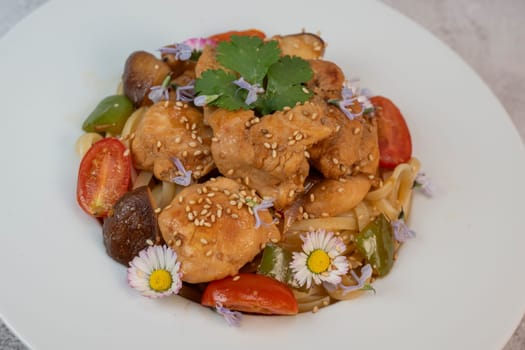 A flavorful blend of chicken, linguine, shiitake mushrooms, bell peppers, and fresh garden flowers offers a vibrant and appetizing meal. Ideal for a cozy dinner or gathering.