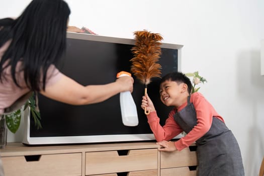 A joyful scene of a mother and her son engaging in house cleaning together, fostering teamwork and responsibility while maintaining a tidy home.
