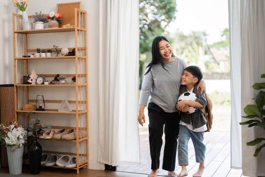 A mother and her son walk hand in hand, ready for school, showcasing the strong bond between them as they embark on a new day of learning and adventure.