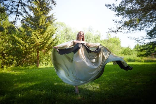 Beautiful dryad or fairy in nature. Pagan spirit of forest. Environmental friendliness, caring for nature. Adult mature woman 40-60 in Photo shoot