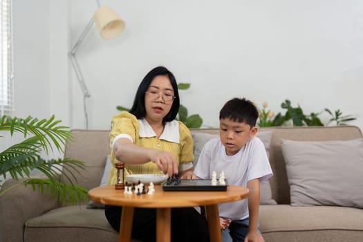 A scene of a mother and her son focused on their chess match in a comfortable living room, enhancing their relationship through playful competition.