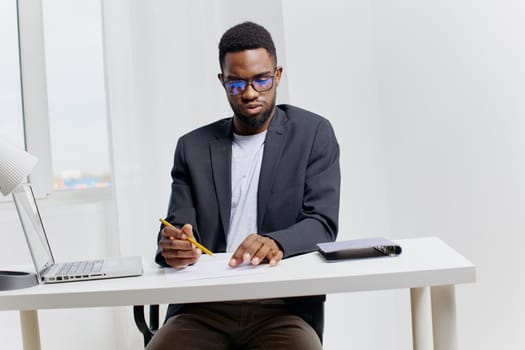 Professional deeply engaged in strategic planning, writing notes with a pen at a desk, focused and concentrated.