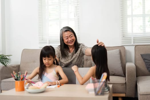 A loving grandmother engages her granddaughters in fun educational activities, fostering a joyful learning environment as they prepare for school.