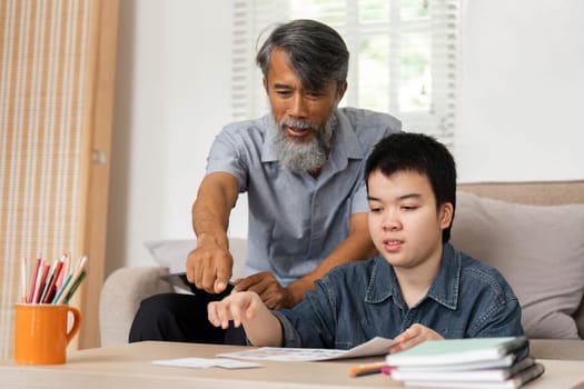 A meaningful moment where a grandfather helps his grandson with educational materials, fostering a supportive learning environment.